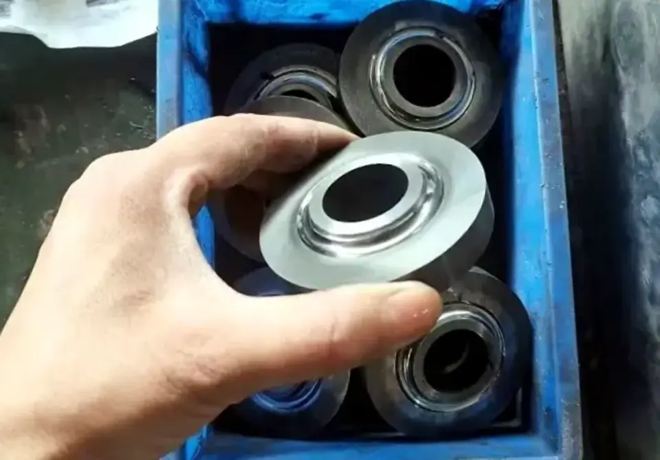 Sintered WC-Co seal rings at production facility — quality check before grinding