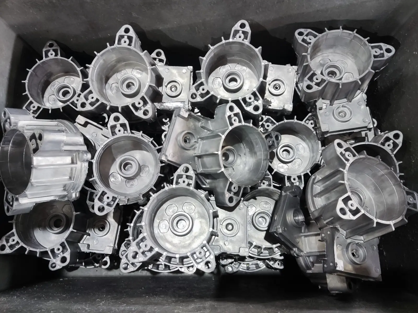 Finished die-cast aluminum housings with machined bearing bores, staged for inspection and shipment